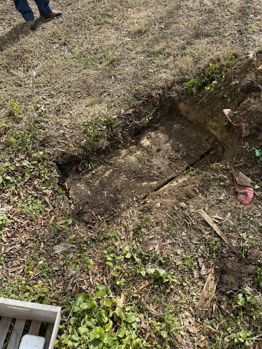 Septic tank access lid uncovered at the tank end